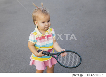 charming little tennis player with a racket  103270623