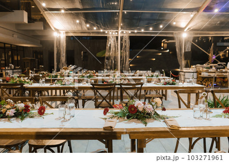 Wedding reception night dinner setup table with beautiful flower decoration. 103271961
