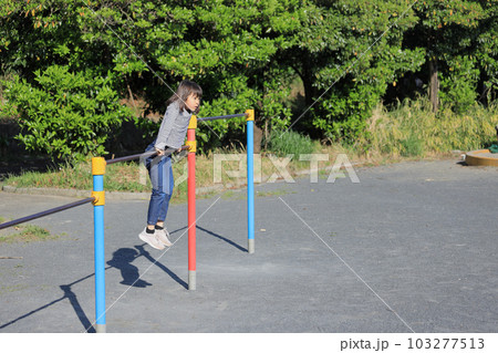 鉄棒をする女子小学生 (8歳) 103277513