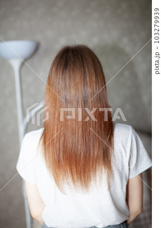 A girl with long, straight and beautiful brown hair. Hair care at home 103279939
