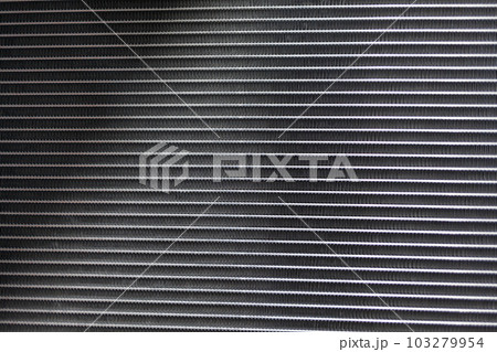 The texture of the car radiator. Engine cooler background. The texture of the car radiator. Engine cooler background. 103279954