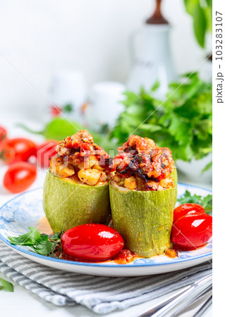 Zucchini stuffed with chicken and vegetables. 103283107