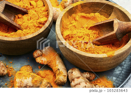 Turmeric root and curcuma powder. Turmeric root and curcuma powder. 103283643