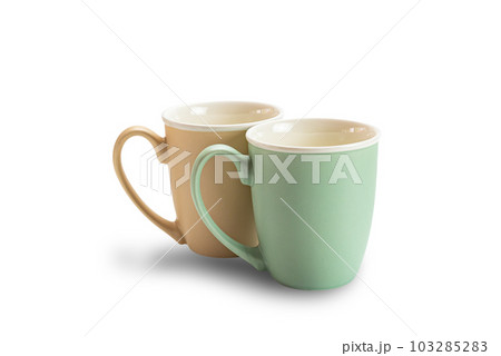 View of two empty ceramic coffee mugs brown and green isolated on white background. 103285283