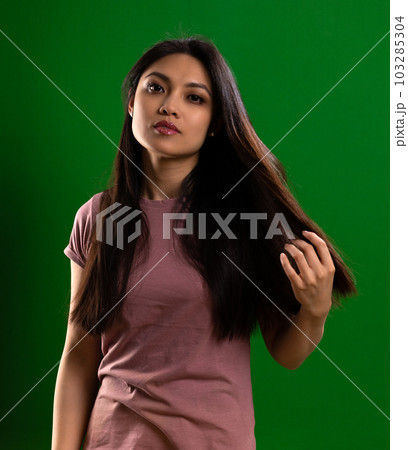 Young Asian woman with a beautiful face - portrait shot against color background Young Asian woman with a beautiful face - portrait shot against color background 103285304