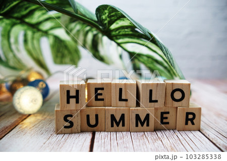 Hello Summer alphabet letters with monstera leave and LED cotton balls decoration on wooden background Hello Summer alphabet letters with monstera leave and LED cotton balls decoration on wooden background 103285338