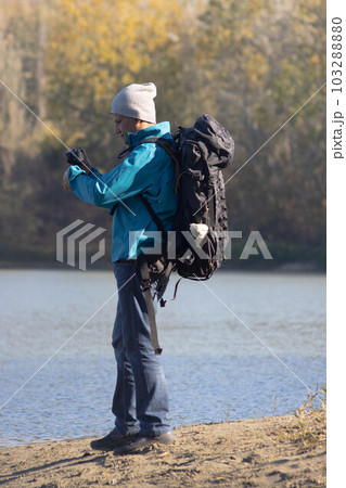 Portrait of traveler man at lake in autumn Portrait of traveler man at lake in autumn 103288880