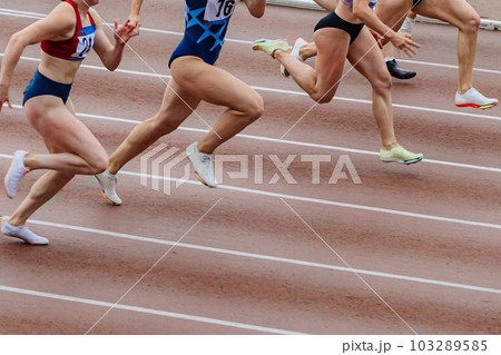 group female athletes runners running together sprint race in track, summer championship athletics 103289585