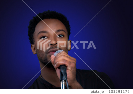 rock music singer holding microphone on blue background party karaoke performance 103291173