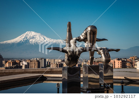 Cityscape with mountain view in the morning time concept photo. Modern art - stainless steel sculptures Cityscape with mountain view in the morning time concept photo. Modern art - stainless steel sculptures 103292117