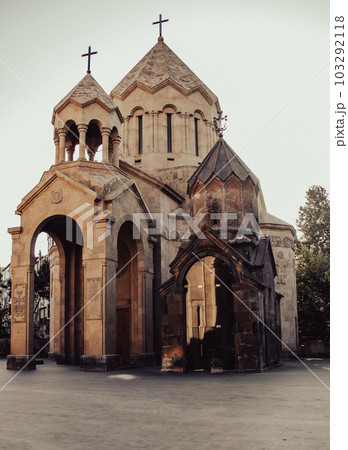 Ancient church with spires in Yerevan cityscape photo. 103292118