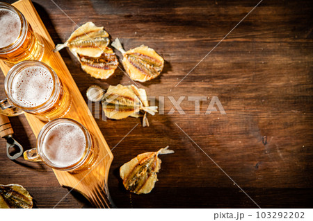Glasses of beer with dried fish. Glasses of beer with dried fish. 103292202