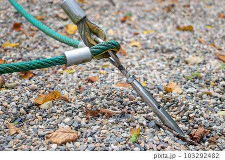 A construction of ropes mounted in the ground with gravel 103292482