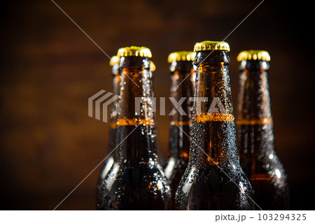 Fresh beer in closed bottles. Fresh beer in closed bottles. 103294325