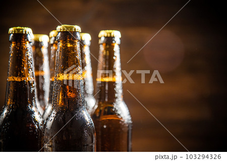 Fresh beer in closed bottles. Fresh beer in closed bottles. 103294326