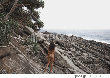 Wild Rocky Beach Landscape with Nudist Beach Woman 103294560
