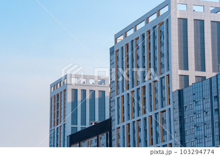 cityscape, urban background, group of facades of modern high-rise buildings against the sky 103294774