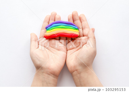 The child sculpts makes a rainbow from plasticine. Children's creativity. 103295153