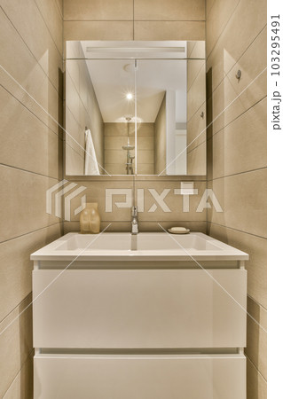 a bathroom with a sink and mirror on the wall next to it is an image of a toilet in the corner a bathroom with a sink and mirror on the wall next to it is an image of a toilet in the corner 103295491