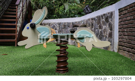 Bunny swing metal spring or spring rider at the children playground. 103297804