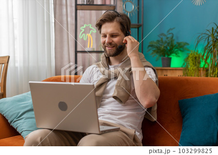 Young man freelance worker call center or support service operator helpline having talk with client 103299825