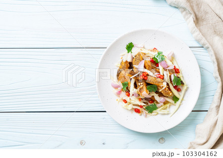 crispy gourami fish with spicy salad crispy gourami fish with spicy salad 103304162