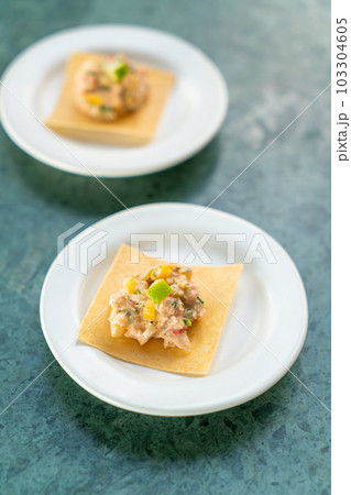 salmon with fruits salad sauce on cracker 103304605