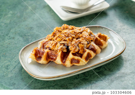 Croffles with almond and caramel - Food Trend that compound word from Croissant and Waffle 103304606