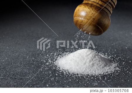 closeup of salt falling from wooden shaker to heap closeup of salt falling from wooden shaker to heap 103305708