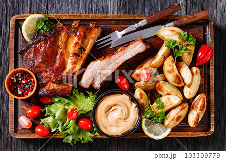 juicy roast pork ribs with veggies, top view 103309779