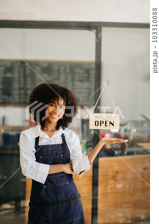 Startup successful small business owner sme African woman stand with tablet  in cafe restaurant. woman barista cafe owner. . Startup successful small business owner sme African woman stand with tablet  in cafe restaurant. woman barista cafe owner. . 103310088