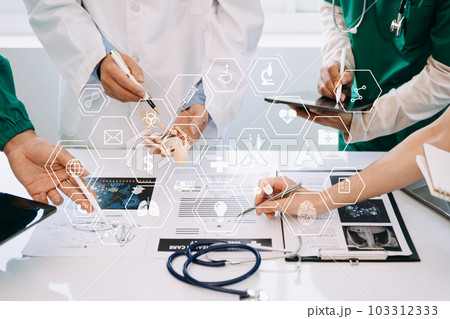 Medical technology network team meeting concept. Doctor hand working with smart phone modern digital tablet and laptop computer with graphics chart interface, with virtual icon 103312333