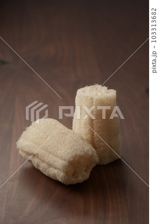 Organic loofah bath scrub on walnut table Organic loofah bath scrub on walnut table 103313682