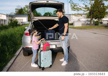 Father help daughter loading to the trunk with luggage before traveling while mom packs her luggage Father help daughter loading to the trunk with luggage before traveling while mom packs her luggage 103313683