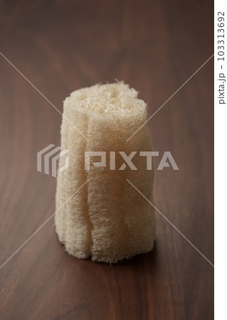 Organic loofah bath scrub on walnut table 103313692