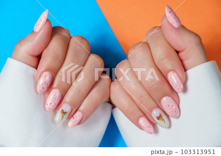 Women's manicure in pink, close-up. A woman's hand with a beautiful pink manicure. 103313951