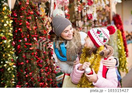 Girl with mom buying decorations Girl with mom buying decorations 103315427