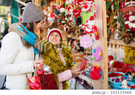 Girl with mom buying decorations 103315460