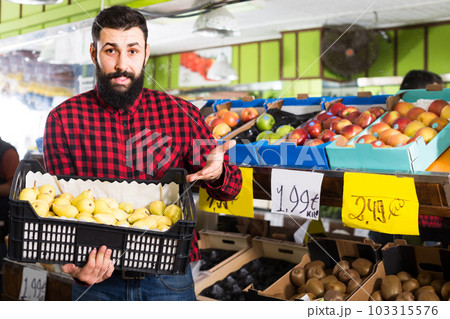 man seller showing pears man seller showing pears 103315576