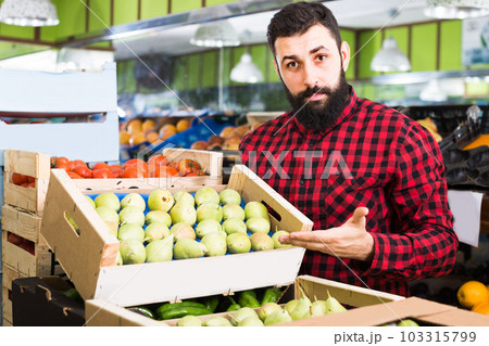 man seller showing pears man seller showing pears 103315799