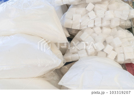 cube and granulated sugar in transparent bags at market 103319207