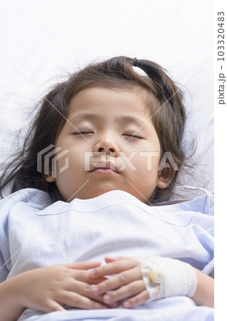 Little Asian Thai Girl, Recovering Sleep on white patient Bed Background. Little Asian Thai Girl, Recovering Sleep on white patient Bed Background. 103320483