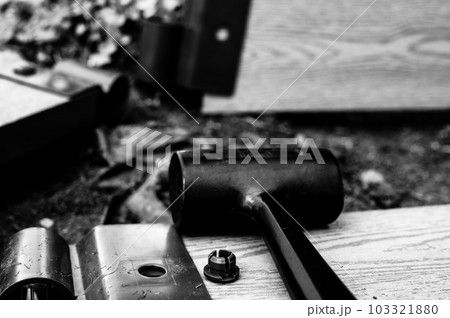 Assembling a raised bed garden panel with plastic connectors using a rubber mallet.  103321880