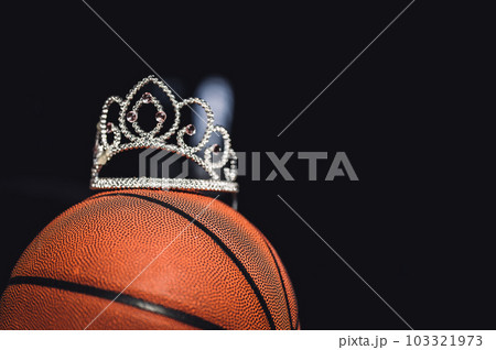 Basketball, tiara, and blank bracket signifying a Cinderella season. 103321973