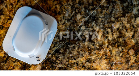 Ant trap poison bate on a granite kitchen countertop 103322054