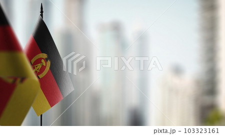 Small flags of the GDR on an abstract blurry background 103323161