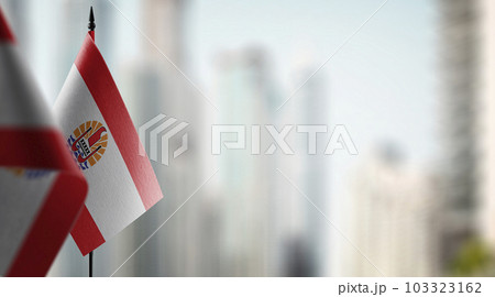 Small flags of the French Polynesia on an abstract blurry background 103323162