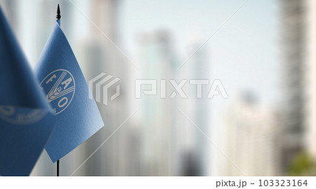Small flags of the Food and agriculture organization on an abstract blurry background Small flags of the Food and agriculture organization on an abstract blurry background 103323164