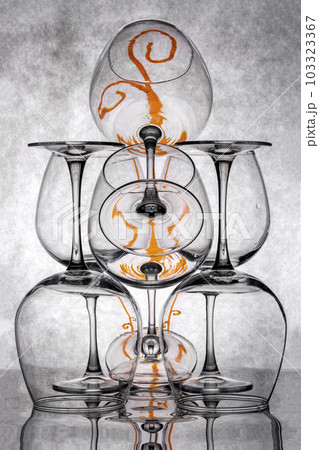 Still life with glass objects on a gray background 103323367