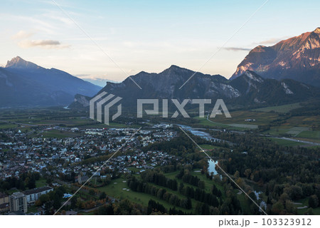 Panorama of the city of Bad Ragaz against the background of the Swiss Alps at sunset. Bad Ragaz Switzerland. Aerial view. Top view Panorama of the city of Bad Ragaz against the background of the Swiss Alps at sunset. Bad Ragaz Switzerland. Aerial view. Top view 103323912
